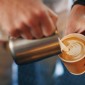 Pouring milk into a coffee 