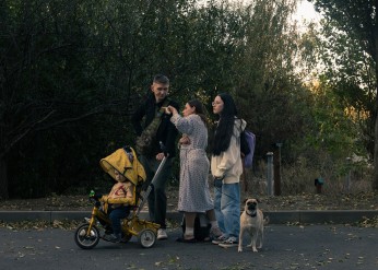 A family walks down a street following an airstrike