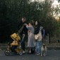 A family walks down a street following an airstrike