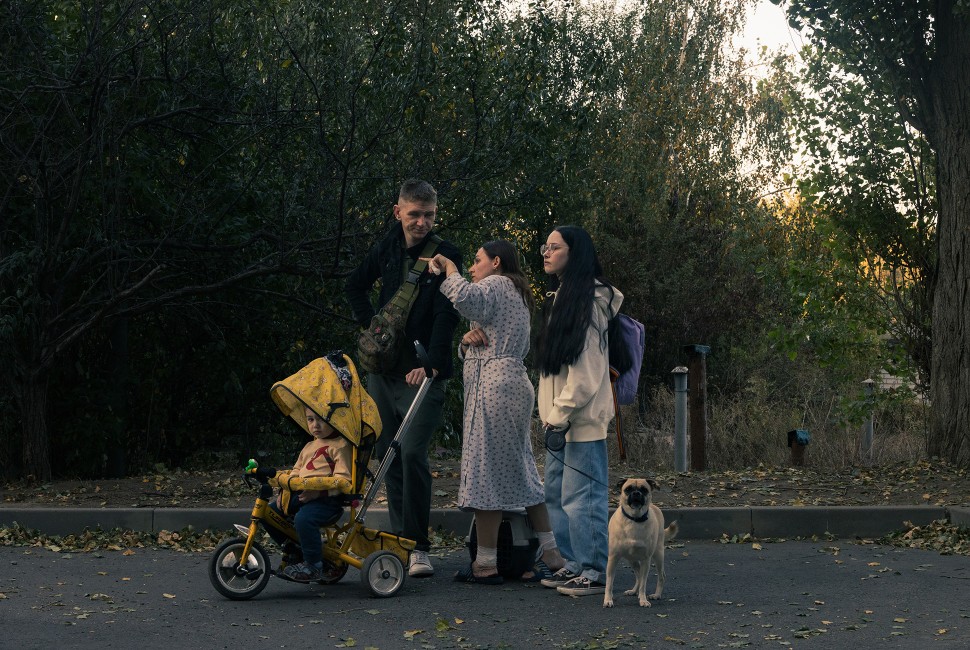 A family walks down a street following an airstrike