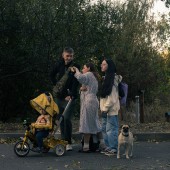 A family walks down a street following an airstrike