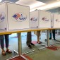 People vote behind privacy dividers 