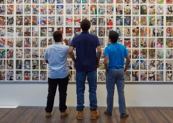 three people look at a collage