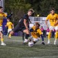 A Northwestern men's soccer player takes on Michigan players