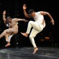 Three members of the Sankofa Danzafro company perform in a black box theater