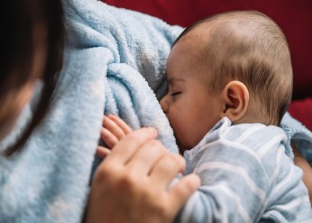 close-up of baby breastfeeding