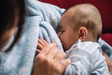 close-up of baby breastfeeding