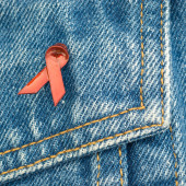 An HIV awareness ribbon on a denim background