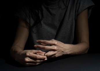 hands removing a wedding ring