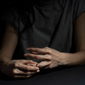 hands removing a wedding ring