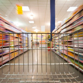 an empty shopping cart going down a grocery aisle