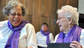 Two members of the Good Memories Choir laugh during a pre-concert warmup at the Buchanan Chapel at Fourth Presbyterian Church in Chicago.