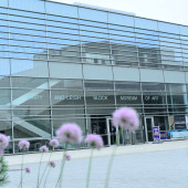 Exterior photo of The Block Museum with purple flowers in the foreground