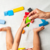 Infant playing with colored blocks
