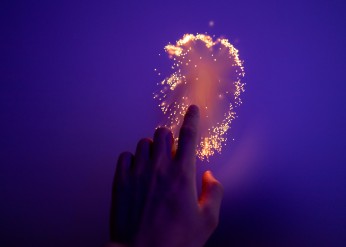 Hand touching glowing surface