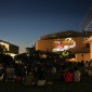 Summer Cinema attendees watch a movie on the Arts Green Lawn at dusk