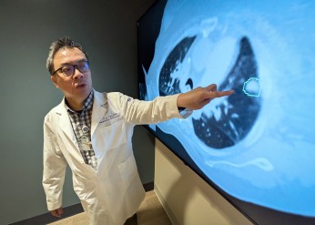 Troy Teo points to an image on a screen