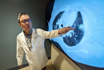 Troy Teo points to an image on a screen