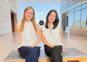 Klara Vinn, left, and Justine Liu, right, pose in the atrium of the Ryan Center for the Arts