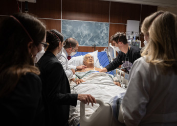 Dr. Brian Garibaldi talks to a patient with an audience of students