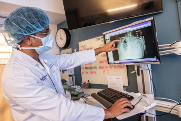 Dr. Ankit Bharat points to a chest scan