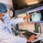 Dr. Ankit Bharat points to a chest scan