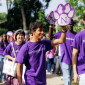 Students wear purple Northwestern shirts as they walk under the Weber Arch