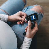a pregnant person checks their glucose levels 
