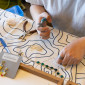 An artist's hands hold pliers while creating jewelry at last year's Spring Arts and Crafts Fair