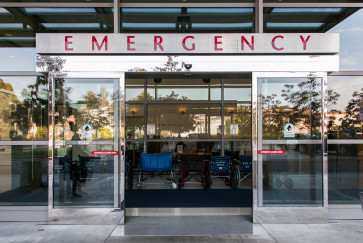 Automatic sliding doors under a sign reading Emergency