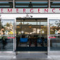 Automatic sliding doors under a sign reading Emergency