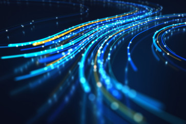 Bright blue lines of lit fiber optic cables curve around on a dark background