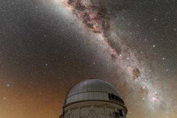 The Milky Way shines over the dome of an observatory